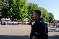Policjant przemawia do dzieci podczas rozpoczęcia roku szkolnego.