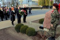 delegacja urzędników składa wiązankę kwiatów pod pomnikiem